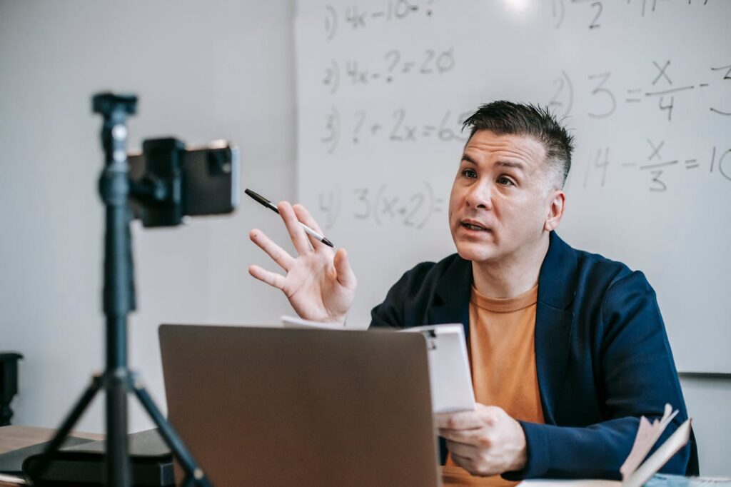 Photo Of Man Talking In Front Of Camera making a tutorial or webinar